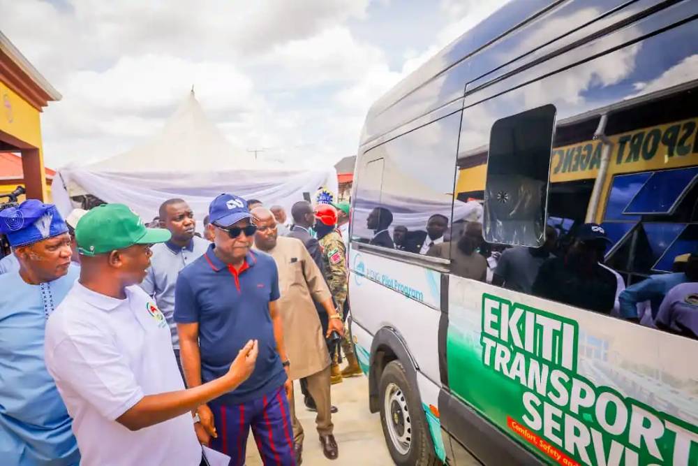 Officials gathered around a new Ekiti Transport Service vehicle.