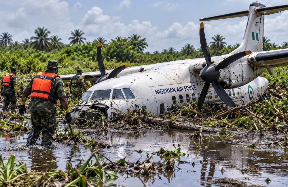 Crashed Nigerian Air Force plane in a swampy area.
