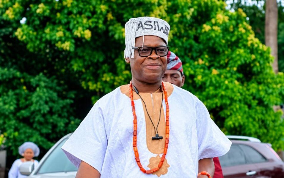 Man in traditional Nigerian attire and white beaded cap.