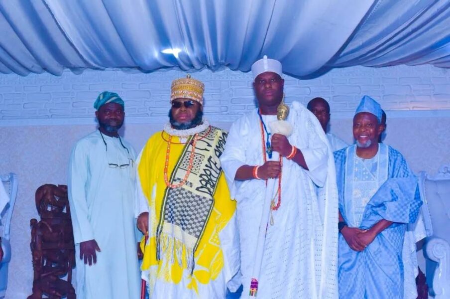 Nigerian traditional rulers in ceremonial attire standing together.